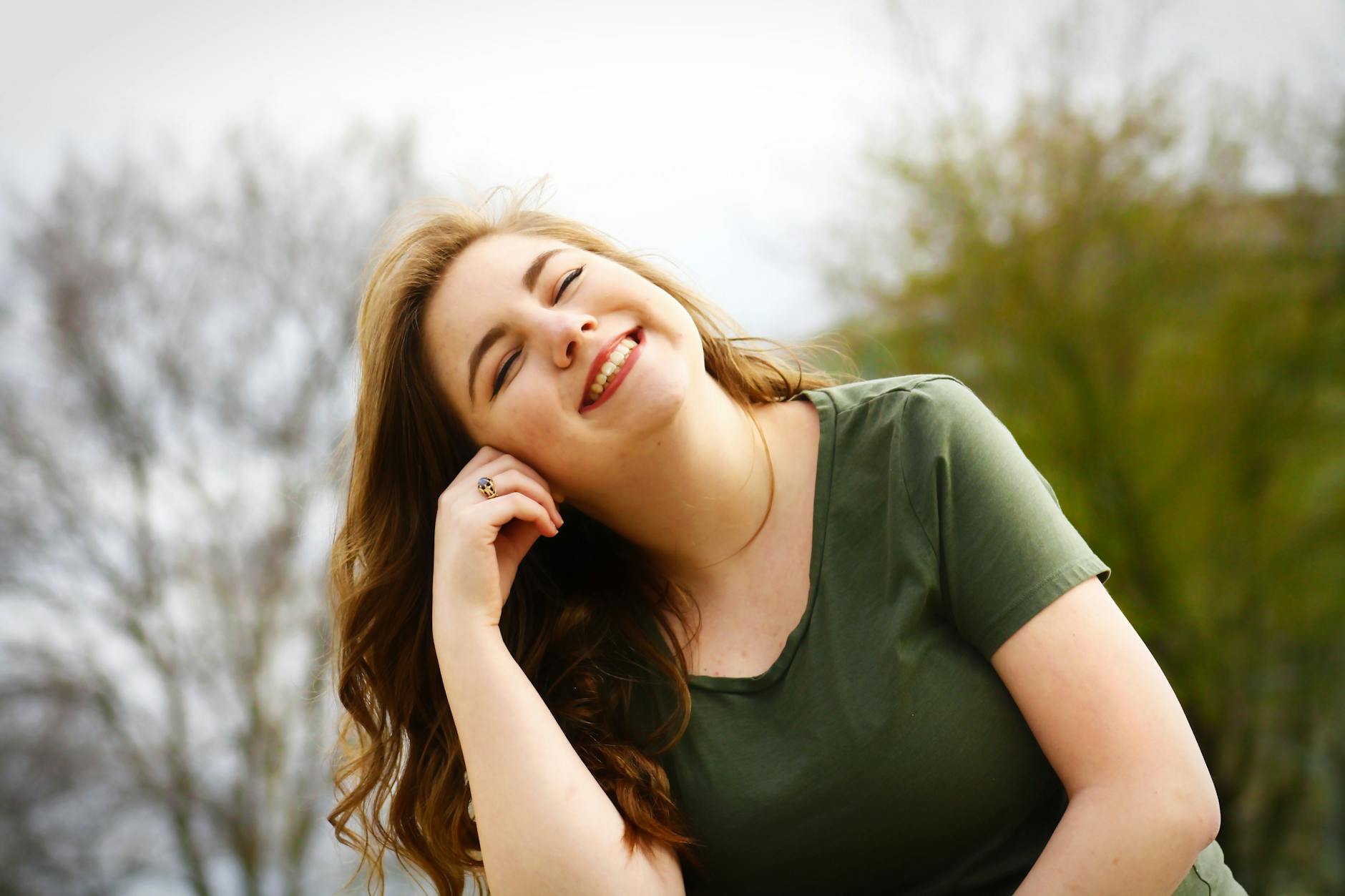 woman in green shirt smiling